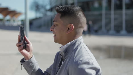 Smiling-young-man-having-video-call-through-broken-smartphone